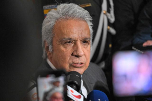 (FILES) Ecuador's former president (20172021) Lenin Moreno speaks with the media as he leaves the National Court of Justice over a corruption case in Quito, on May 11, 2026. An Ecuadoran court on August 28, 2026 convicted former leftist president Lenin Moreno of accepting millions of dollars in bribes linked to the construction of a hydroelectric plant. The Attorney General's Office said Moreno, who served as president from 2017 to 2021, was among four people convicted in the case involving a plant built by Chinese company Sinohydro during his tenure as vice president. (Photo by Rodrigo BUENDIA / AFP)