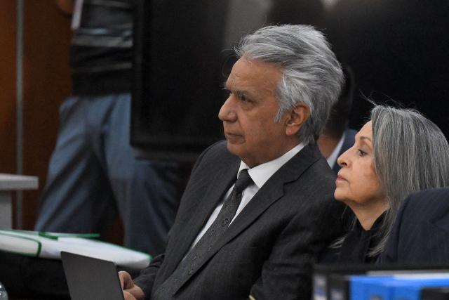 (FILES) Ecuador's former President (2017-2021) Lenin Moreno (L) appears at the National Court of Justice over a corruption case next to his wife Rocio Gonzalez (R) in Quito, on May 11, 2026. An Ecuadoran court on August 28, 2026 convicted former leftist president Lenin Moreno of accepting millions of dollars in bribes linked to the construction of a hydroelectric plant. The Attorney General's Office said Moreno, who served as president from 2017 to 2021, was among four people convicted in the case involving a plant built by Chinese company Sinohydro during his tenure as vice president. (Photo by Rodrigo BUENDIA / AFP)