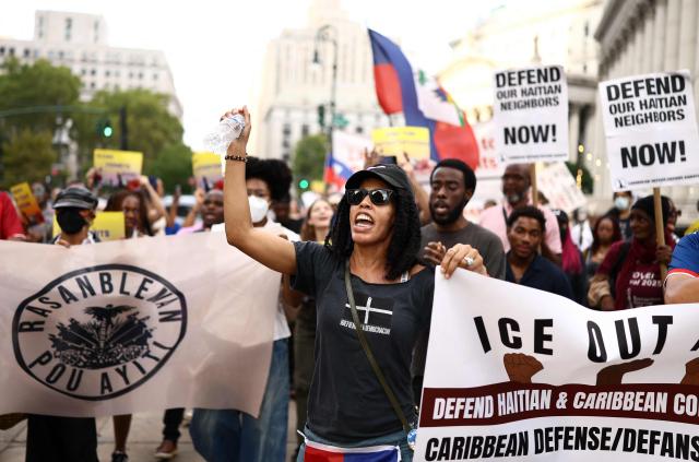 People hold signs during a protest against the termination of Temporary Protected Status (TPS) for the Haitian community and to end mass deportations, at Foley Square in New York City on August 28, 2026. The Supreme Court said in late June 2026 that the Trump administration is allowed to end Temporary Protected Status (TPS) for Haitians and some 6,000 Syrians without judicial review, although the impact of the decision could apply to migrants from many other backgrounds. An estimated 350,000 Haitians live in the United States under the program, with many working in healthcare and construction. (Photo by CHARLY TRIBALLEAU / AFP)