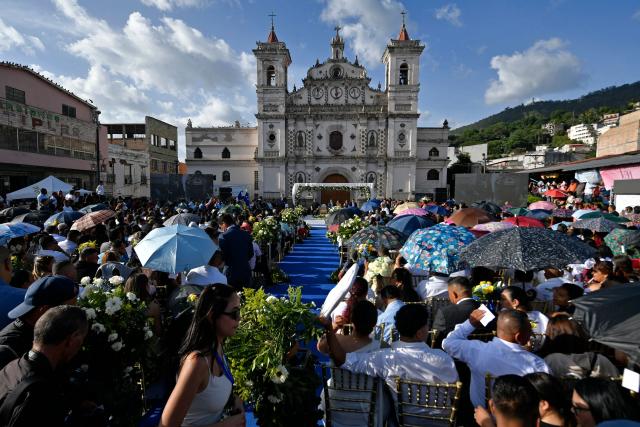 Several couples get married in a mass wedding as part of the Family Month celebration in front of the Church of Santa Maria de los Dolores in Tegucigalpa on August 28, 2026. (Photo by Orlando SIERRA / AFP)