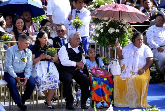 Several couples get married in a mass wedding as part of the Family Month celebration in front of the Church of Santa Maria de los Dolores in Tegucigalpa on August 28, 2026. (Photo by Orlando SIERRA / AFP)