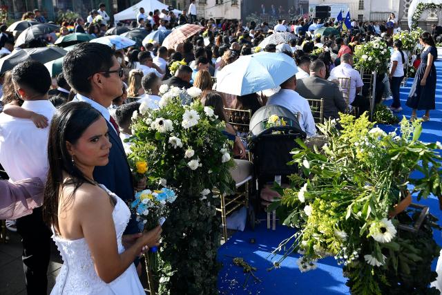 Several couples get married in a mass wedding as part of the Family Month celebration in front of the Church of Santa Maria de los Dolores in Tegucigalpa on August 28, 2026. (Photo by Orlando SIERRA / AFP)