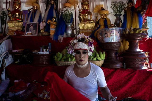A spirit medium, known locally as a "Nat-kadaw," prepares before performing a ritual dance during the annual Taungbyone Spirit Festival in Madaya township, Mandalay region on August 26, 2026. As monsoon rains pound the heartlands of war-fractured Myanmar, "spirit consorts" gather to renew their vows with a pantheon of gods hailed for their powers to protect and destroy. (Photo by SAI AUNG MAIN / AFP) / TO GO WITH AFP STORY: Myanmar-religion-festival-conflict, FOCUS