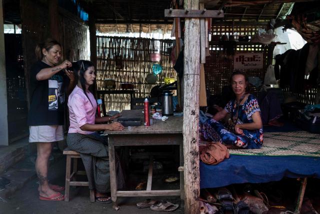 A spirit medium, known locally as a "Nat-kadaw," prepares before performing a ritual dance during the annual Taungbyone Spirit Festival in Madaya township, Mandalay region on August 26, 2026. As monsoon rains pound the heartlands of war-fractured Myanmar, "spirit consorts" gather to renew their vows with a pantheon of gods hailed for their powers to protect and destroy. (Photo by SAI AUNG MAIN / AFP) / TO GO WITH AFP STORY: Myanmar-religion-festival-conflict, FOCUS