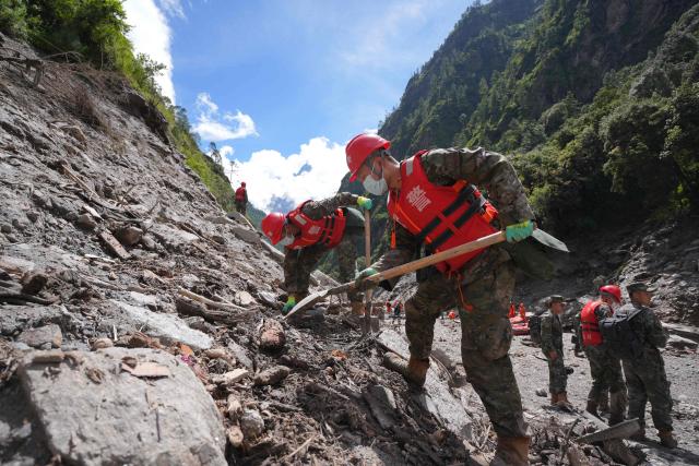 Paramilitary police conduct search and rescue operations on a hillside 2 kilometers from Gyirong Port which was damaged after a mudslide two days earlier, in Gyirong County, in China’s western Tibet region on August 28, 2026. (Photo by CNS / AFP) / China OUT