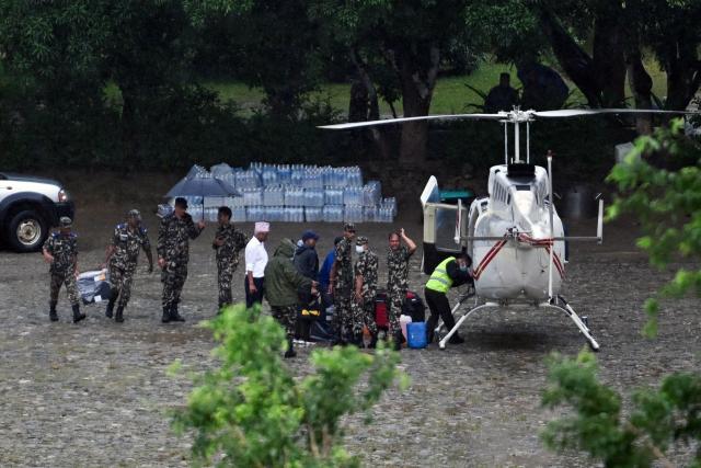 Nepali soldiers load relief supplies onto a helicopter at Trishuli in Nepal's Nuwakot district on August 29, 2026, after flash floods and landslides hit the Nepal-Tibet border. Rescuers in Nepal and China were still battling August 29 to locate thousands of people missing days after a deadly, tsunami-like wall of water and debris swept through the Himalayan region, engulfing villages. (Photo by Arun SANKAR / AFP)