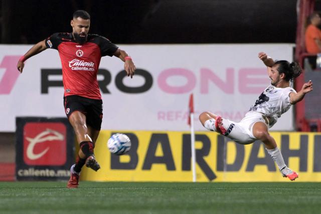 Tijuana's Moroccan forward Mourad El Ghezouani (L) kicks the ball past Pumas' defender #02 Pablo Bennevendo (R) during the Liga MX Apertura tournament football match between Tijuana and Pumas at the Caliente stadium in Tijuana, Baja California state, Mexico, on August 28, 2026. (Photo by Guillermo Arias / AFP)
