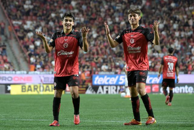 Tijuana's midfielder #10 Gilberto Mora (L) celebrates scoring his team's second goal with teammate forward #17 Ramiro Arciga (R) during the Liga MX Apertura tournament football match between Tijuana and Pumas at the Caliente stadium in Tijuana, Baja California state, Mexico, on August 28, 2026. (Photo by Guillermo Arias / AFP)