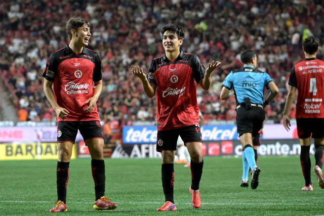 Tijuana's midfielder #10 Gilberto Mora (R) celebrates scoring his team's second goal with teammate forward #17 Ramiro Arciga (L) during the Liga MX Apertura tournament football match between Tijuana and Pumas at the Caliente stadium in Tijuana, Baja California state, Mexico, on August 28, 2026. (Photo by Guillermo Arias / AFP)
