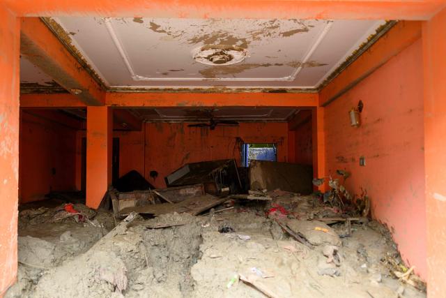 A room is seen heavily covered in mud inside a house in the aftermath of flash floods at Devighat in Nepal's Nuwakot district on August 29, 2026. Rescuers in Nepal and China were still battling on August 29 to locate thousands of people missing days after a deadly, tsunami-like wall of water and debris swept through the Himalayan region, engulfing villages. Nearly 3,000 people were still missing on August 29 and 633 confirmed dead after flash floods and landslides hit the Nepal-Tibet border. (Photo by Manan VATSYAYANA / AFP)