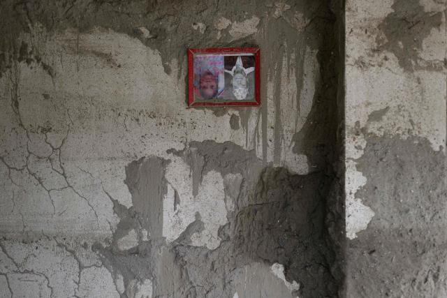 A couple's portrait hangs inside a room heavily covered in mud following flash floods at Devighat in Nepal’s Nuwakot district on August 29, 2026. Rescuers in Nepal and China were still battling on August 29 to locate thousands of people missing days after a deadly, tsunami-like wall of water and debris swept through the Himalayan region, engulfing villages. Nearly 3,000 people were still missing on August 29 and 633 confirmed dead after flash floods and landslides hit the Nepal-Tibet border. (Photo by Manan VATSYAYANA / AFP)