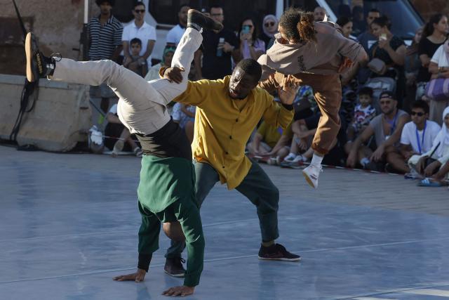 Contemporary dancers perform for the audience during the Karacena International Biennial of Circus Arts and Travel in Sale on August 28, 2026. Karacena 2026, organised by AMESIP (Moroccan Association for Assistance to Children in Vulnerable Situations) in partnership with the Shems’y National Circus School, brings together Moroccan and international artists through contemporary circus, dance, music, street arts, and equestrian arts. (Photo by Abdelmajid BZIOUAT / AFP)