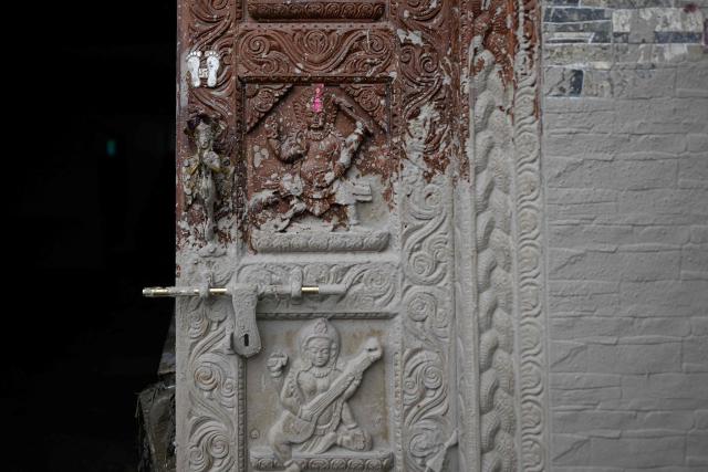 Mud marks are seen on a house door in the aftermath of flash floods at Devighat in Nepal's Nuwakot district on August 29, 2026. Nearly 3,000 people were still missing on August 29 and 633 confirmed dead after flash floods and landslides hit the Nepal-Tibet border. (Photo by Manan VATSYAYANA / AFP)