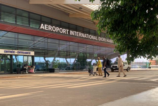 (FILES) Passengers arrive at the Diori Hamani International airport in Niamey on September 22, 2023. Gunfire and explosions were heard on August 29 morning in Niger's capital, Niamey, including around a military base near the city's airport, which has been attacked twice this year by jihadists. Niger has been ruled for three years by a military junta that has struggled to contain jihadist violence, which has blighted the west African country for around a decade. (Photo by AFP)