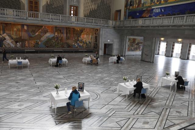 Tables displaying portraits of the late King are set up inside Oslo City Hall in Oslo on August 29, 2026, for members of the public wishing to sign condolence books following his death. King Harald V of Norway, who died on August 28, 2026 aged 89, remained a unifying figure in his country until the very end, a pillar of stability amid a string of family scandals that tarnished the final years of his reign. (Photo by Odd ANDERSEN / AFP)