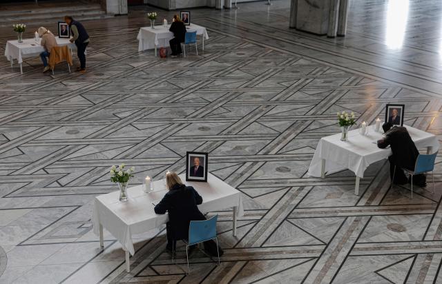TOPSHOT - Tables displaying portraits of the late King are set up inside Oslo City Hall in Oslo on August 29, 2026, for members of the public wishing to sign condolence books following his death. King Harald V of Norway, who died on August 28, 2026 aged 89, remained a unifying figure in his country until the very end, a pillar of stability amid a string of family scandals that tarnished the final years of his reign. (Photo by Odd ANDERSEN / AFP)