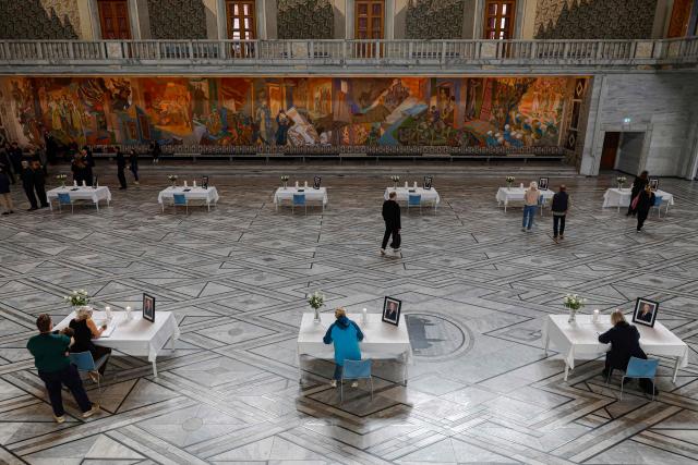 Tables displaying portraits of the late King are set up inside Oslo City Hall in Oslo on August 29, 2026, for members of the public wishing to sign condolence books following his death. King Harald V of Norway, who died on August 28, 2026 aged 89, remained a unifying figure in his country until the very end, a pillar of stability amid a string of family scandals that tarnished the final years of his reign. (Photo by Odd ANDERSEN / AFP)