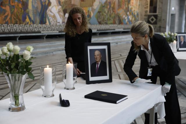 A table displaying a portrait of the late King is being set up inside Oslo City Hall in Oslo on August 29, 2026, for members of the public wishing to sign condolence books following his death. King Harald V of Norway, who died on August 28, 2026 aged 89, remained a unifying figure in his country until the very end, a pillar of stability amid a string of family scandals that tarnished the final years of his reign. (Photo by Odd ANDERSEN / AFP)