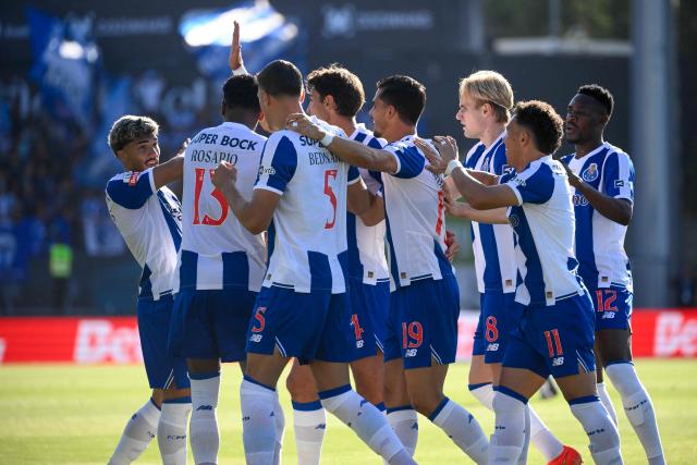 FC Porto's Portuguese forward #19 Andre Silva (L) celebrates scoring his team's first goal during the Portuguese League football match between Academico de Viseu F.C. and FC Porto at Estadio Municipal de Fontelo in Viseu on August 29, 2026. (Photo by Miguel RIOPA / AFP)