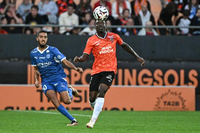 Lorient's Ghanaian defender #32 Nathaniel Adjei (R) controls the ball during the French L1 football match between FC Lorient and ESTAC Troyes at the Stade du Moustoir in Lorient, western France, on August 29, 2026. (Photo by Sebastien Salom-Gomis / AFP)