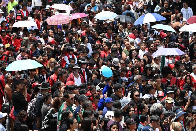 Mexican fans of the late "King of Pop" Michael Jackson perform during the annual event dubbed "I Do Dance to Thriller", held to mark the anniversary of the singer's birth, on the esplanade of the Monument to the Revolution in Mexico City on August 29, 2026. (Photo by Yuri CORTEZ / AFP)