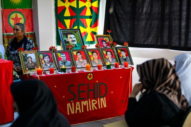 Relatives look at photographs during funeral commemorations of PKK guerrillas who had died as Kurdish families gathered to honor relatives killed in the conflict, in the Kucukcekmece district of Istanbul, on August 29, 2026. With the Turkish Parliament's adoption in mid-August of the Law on the Reintegration of Kurdish Fighters into Civilian Life, following twenty months of peace talks, the lists of "martyrs" are being gradually published by the authorities. (Photo by Yasin AKGUL / AFP)