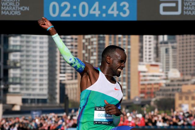 Ethiopia's Addisu Gobena celebrates as he crosses the finish line to win the 2026 Sydney Marathon in Sydney on August 30, 2026. (Photo by DAVID GRAY / AFP)