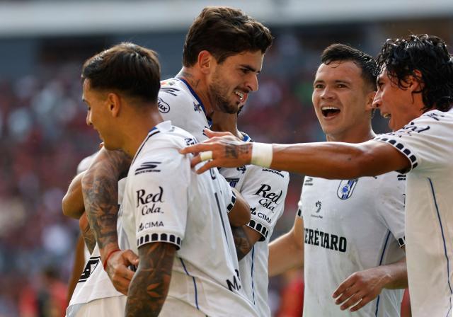 Queretaro's Uruguayan midfielder #05 Santiago Homenchenko (2nd L) celebrates with teammates after scoring a goal during the Liga MX Apertura tournament football match between Atlas and Queretaro, at the Jalisco stadium in Guadalajara, state of Jalisco, Mexico, on August 29, 2026. (Photo by ULISES RUIZ / AFP)