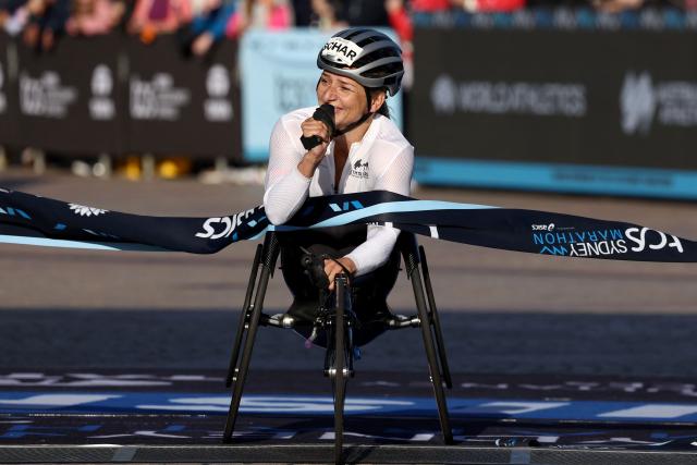 Switzerland’s Manuela Schar reacts as she crosses the finish line to win the Women’s wheelchair category of the 2026 Sydney Marathon in Sydney on August 30, 2026. (Photo by DAVID GRAY / AFP)