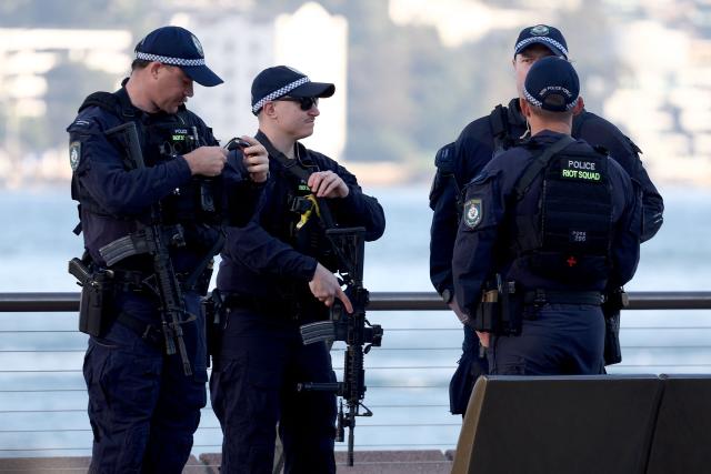 Armed New South Wales police officers stand near the finish line of the 2026 Sydney Marathon in Sydney on August 30, 2026. (Photo by DAVID GRAY / AFP)
