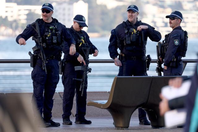 Armed New South Wales police officers stand near the finish line of the 2026 Sydney Marathon in Sydney on August 30, 2026. (Photo by DAVID GRAY / AFP)
