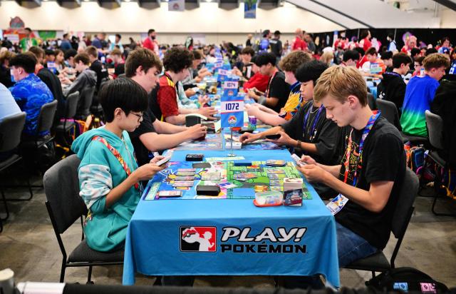 Pokemon trainers compete in the Trading Card Game (TCG) competition during the 2026 Pokemon World Championships and Pokemon XP at the Moscone Center in San Francisco, California on August 29, 2026. More than 50,000 fans are expected to be in attendance for the 3-day event from August 28-30 as the Pokemon World Championships return to San Francisco for the first time in a decade and for Pokemon XP, the first fan convention of its kind. The Pokemon franchise has an estimated global revenue of over $147 billion since launching in 1996, making it the world's most valuable media franchise. (Photo by Frederic J. BROWN / AFP)