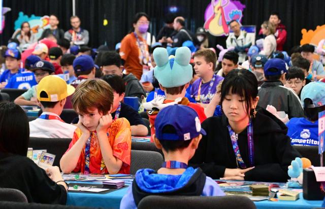 Pokemon trainers compete in the Trading Card Game (TCG) competition during the 2026 Pokemon World Championships and Pokemon XP at the Moscone Center in San Francisco, California on August 29, 2026. More than 50,000 fans are expected to be in attendance for the 3-day event from August 28-30 as the Pokemon World Championships return to San Francisco for the first time in a decade and for Pokemon XP, the first fan convention of its kind. The Pokemon franchise has an estimated global revenue of over $147 billion since launching in 1996, making it the world's most valuable media franchise. (Photo by Frederic J. BROWN / AFP)