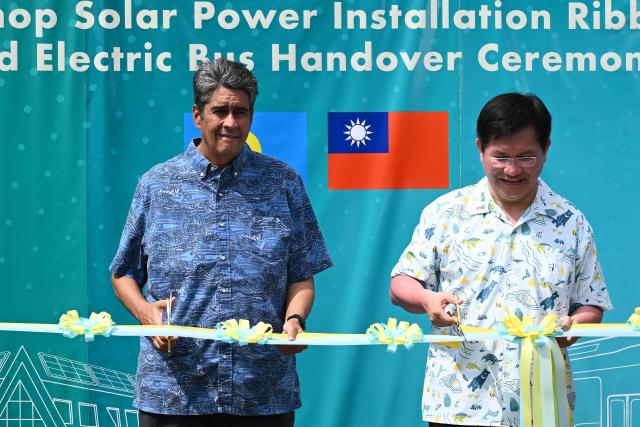 Palau President Surangel S. Whipps Jr. (L) and Taiwan's Foreign Minister Lin Chia-lung cut a ribbon during the inauguration ceremony for Taiwan-funded solar energy and electric bus projects in Koror on August 30, 2026, ahead of the 55th Pacific Islands Forum Leaders Meeting. (Photo by SAEED KHAN / AFP)