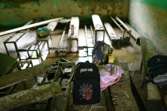 A left-behind Spider-Man school bag is seen inside a classroom heavily covered in mud in the aftermath of flash floods at Bageshwori Secondary School in Galchi town of Nepal's Dhading district on August 30, 2026. The number of people missing in the catastrophic flood that sliced through the border area between Nepal and Tibet exceeded 3,000 on August 30, as rescuers scoured deep, leg-sucking mud for survivors. (Photo by Manan VATSYAYANA / AFP)