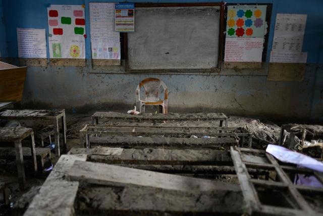 School benches and a teacher's chair are seen inside a classroom heavily covered in mud in the aftermath of flash floods at Bageshwori Secondary School in Galchi town of Nepal's Dhading district on August 30, 2026. The number of people missing in the catastrophic flood that sliced through the border area between Nepal and Tibet exceeded 3,000 on August 30, as rescuers scoured deep, leg-sucking mud for survivors. (Photo by Manan VATSYAYANA / AFP)