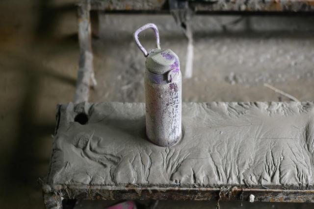A left-behind water bottle is stuck in sludge inside a classroom covered heavily in mud in the aftermath of flash floods at the Bageshwori secondary school in Galchi town of Nepal's Dhading district on August 30, 2026. The number of people missing in the catastrophic flood that sliced through the border area between Nepal and Tibet exceeded 3,000 on August 30, as rescuers scoured deep, leg-sucking mud for survivors. (Photo by Manan VATSYAYANA / AFP)