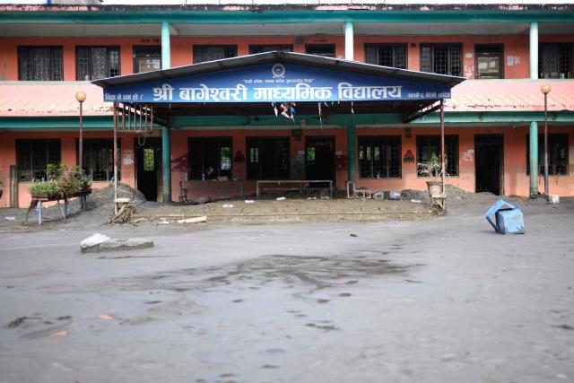 A general view shows the Bageshwori secondary school complex covered heavily in mud in the aftermath of flash floods in Galchi town of Nepal's Dhading district on August 30, 2026. The number of people missing in the catastrophic flood that sliced through the border area between Nepal and Tibet exceeded 3,000 on August 30, as rescuers scoured deep, leg-sucking mud for survivors. (Photo by Manan VATSYAYANA / AFP)