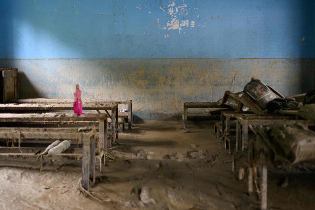 A mark showing the mud level is seen on a wall inside a classroom heavily covered in sludge in the aftermath of flash floods at Bageshwori Secondary School in Galchi town of Nepal’s Dhading district on August 30, 2026. The number of people missing in the catastrophic flood that sliced through the border area between Nepal and Tibet exceeded 3,000 on August 30, as rescuers scoured deep, leg-sucking mud for survivors. (Photo by Manan VATSYAYANA / AFP)