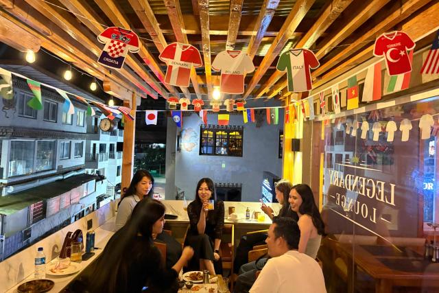 Youngsters enjoy their drinks at a bar along a street in Thimphu, Bhutan, on August 29, 2026. (Photo by Niharika KULKARNI / AFP)