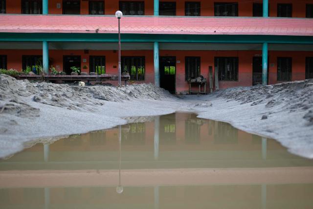 A general view shows the Bageshwori secondary school complex covered heavily in sludge in the aftermath of flash floods in Galchi town of Nepal's Dhading district on August 30, 2026. The number of people missing in the catastrophic flood that sliced through the border area between Nepal and Tibet exceeded 3,000 on August 30, as rescuers scoured deep, leg-sucking mud for survivors. (Photo by Manan VATSYAYANA / AFP)