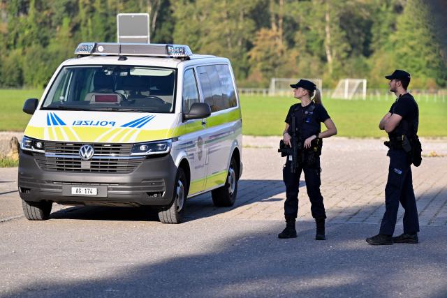 Police officers secure the area near the site of a shooting in Aarau, northern Switzerland, on 30 August 2026. One person was killed and five others were wounded, some of them seriously, in a shooting at a rave party in northern Switzerland, local police said. (Photo by Harold CUNNINGHAM / AFP)
