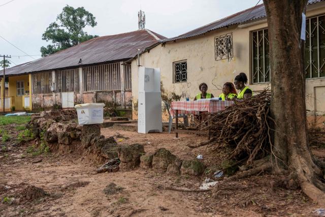 Electoral officials wait for voters at a voting station during Guinea-Bissau's constitutional referendum in Bissau, on August 30 2026. Voters in military-run Guinea-Bissau cast their ballots on August 30 in a referendum that could give the president more powers ahead of a general election meant to restore civilian rule later this year. Voting got off to a slow start in some neighbourhoods when polls opened at 0700 GMT, AFP correspondents said, after a heavy early morning downpour. (Photo by Samba BALDE / AFP)