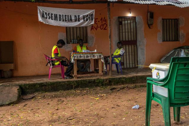 Electoral officials wait for voters at a voting station during Guinea-Bissau's constitutional referendum in Bissau, on August 30 2026. Voters in military-run Guinea-Bissau cast their ballots on August 30 in a referendum that could give the president more powers ahead of a general election meant to restore civilian rule later this year. Voting got off to a slow start in some neighbourhoods when polls opened at 0700 GMT, AFP correspondents said, after a heavy early morning downpour. (Photo by Samba BALDE / AFP)