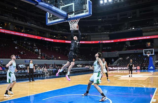 New Zealand's Carlin Davidson (c) jumps shot against Syria during their 2027 FIBA Basketball World Cup Asian qualifier group E match at the Mall of Asia Arena in Pasay city, Metro Manila on August 30, 2026. (Photo by Ted ALJIBE / AFP)