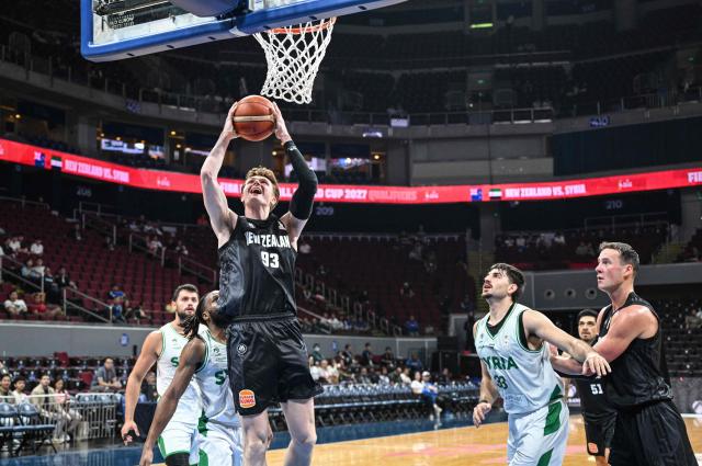 New Zealand's Sam Waardenbu (C) lays up against Syria during their 2027 FIBA Basketball World Cup Asian qualifier group E match at the Mall of Asia Arena in Pasay city, Metro Manila on August 30, 2026. (Photo by Ted ALJIBE / AFP)