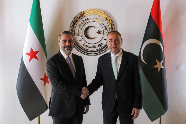 Libya's Tripoli-based Government of National Unity (GNU) Foreign Minister Taher al-Baour (R) receives Syria's interim foreign minister Asaad Shaibani (L) at the ministry headquarters in Tripoli on August 30, 2026. (Photo by Mahmud Turkia / AFP)