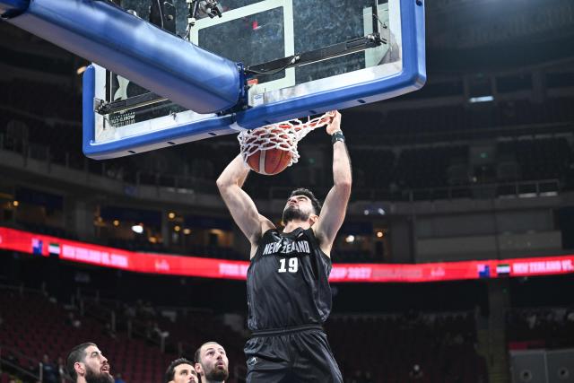 New Zealand's Luca Yates dunks against Syria during their 2027 FIBA Basketball World Cup Asian qualifier group E match at the Mall of Asia Arena in Pasay city, Metro Manila on August 30, 2026. (Photo by Ted ALJIBE / AFP)