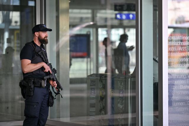 A police officer stands near Aarau railway station following a shooting at a rave in Aarau, northern Switzerland, on 30 August 2026. One person was killed and five others were wounded, some of them seriously, in a shooting at a rave party in northern Switzerland, local police said. (Photo by Harold CUNNINGHAM / AFP)