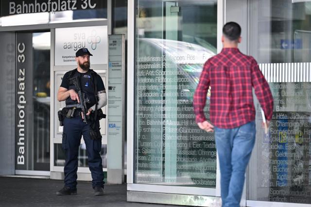 A police officer stands at Aarau railway station following a shooting at a rave in Aarau, northern Switzerland, on 30 August 2026. One person was killed and five others were wounded, some of them seriously, in a shooting at a rave party in northern Switzerland, local police said. (Photo by Harold CUNNINGHAM / AFP)